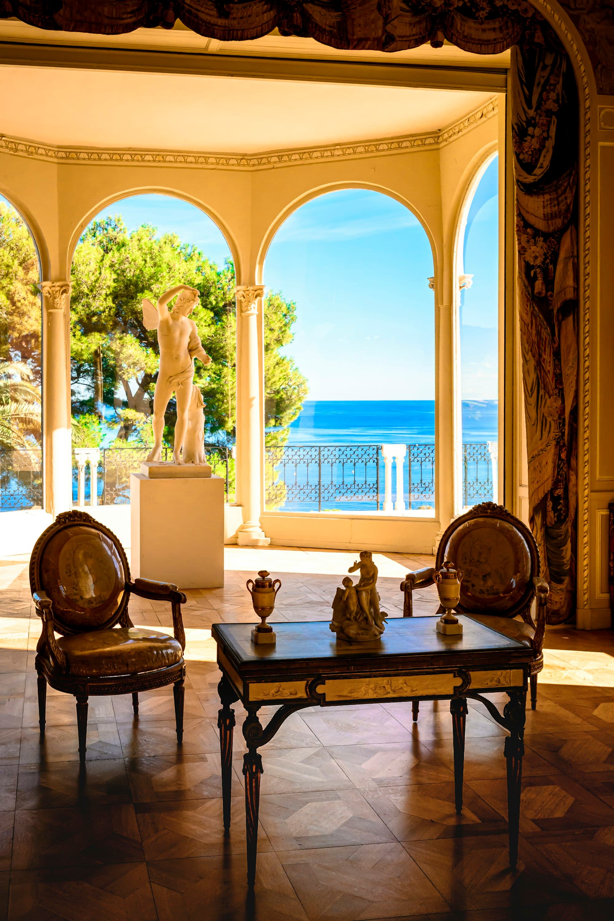 A Riviera interior, sea view through arched doors